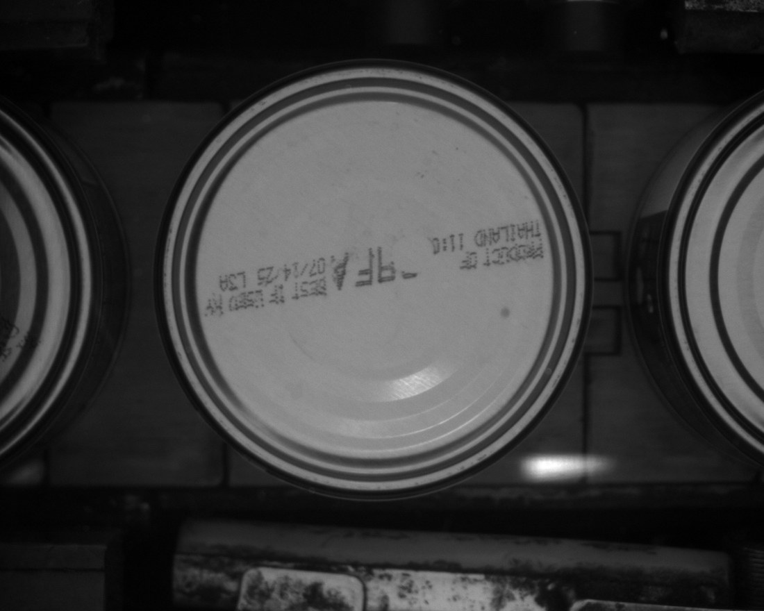 Machine vision frame of a can bottom where the code has rotated toward the edge and is partly obscured