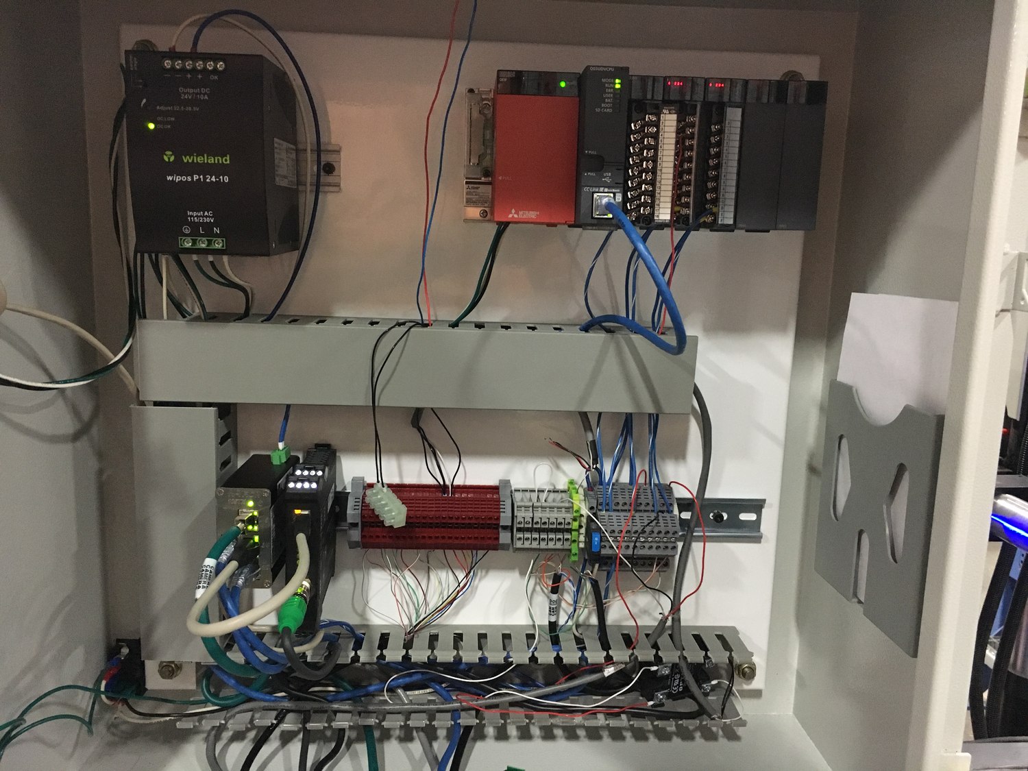 Control enclosure with PLC and wiring built in-house