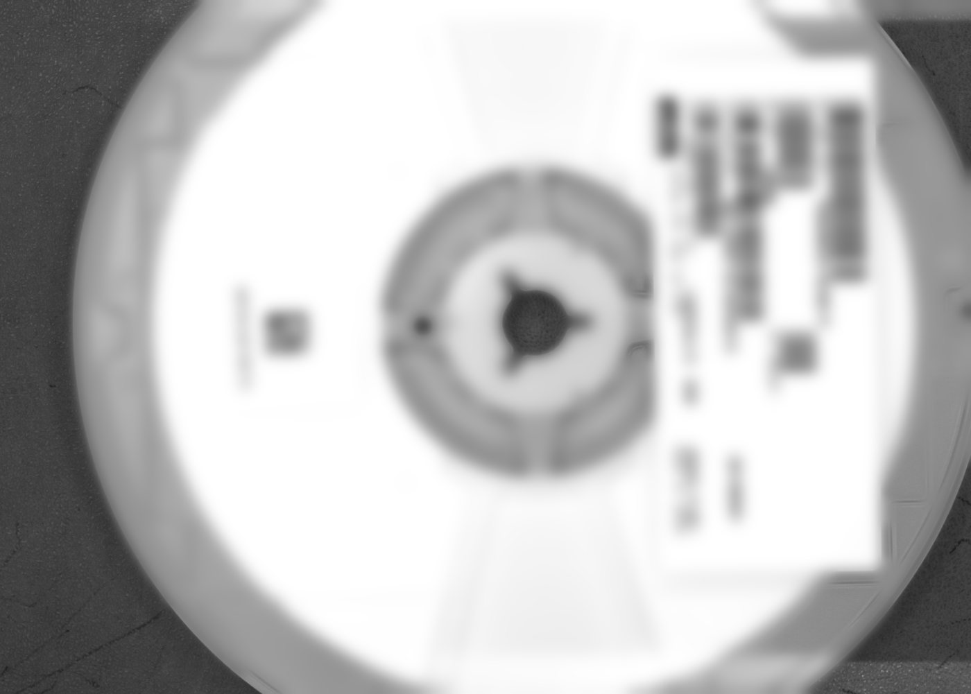 Component reel with a tall label reaching in toward the hub; label text blurred