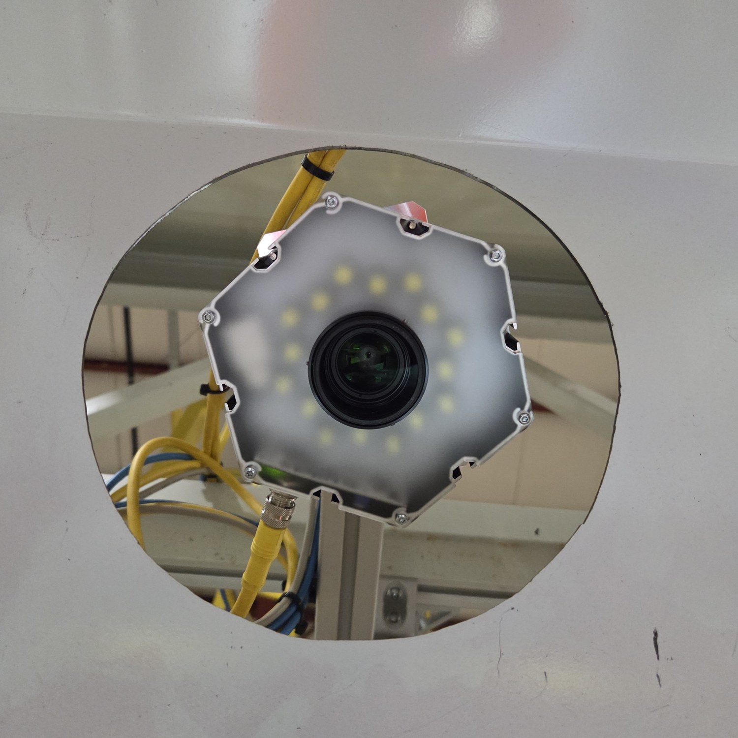 The camera and its ring light seen through an access port above the fill point