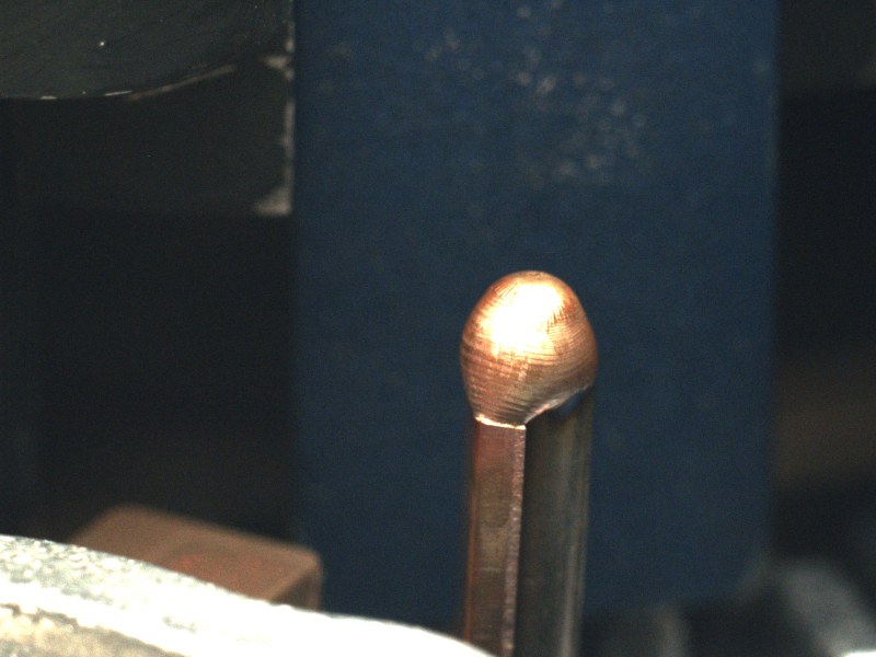 A correctly formed weld bead sitting symmetrically on the copper lead
