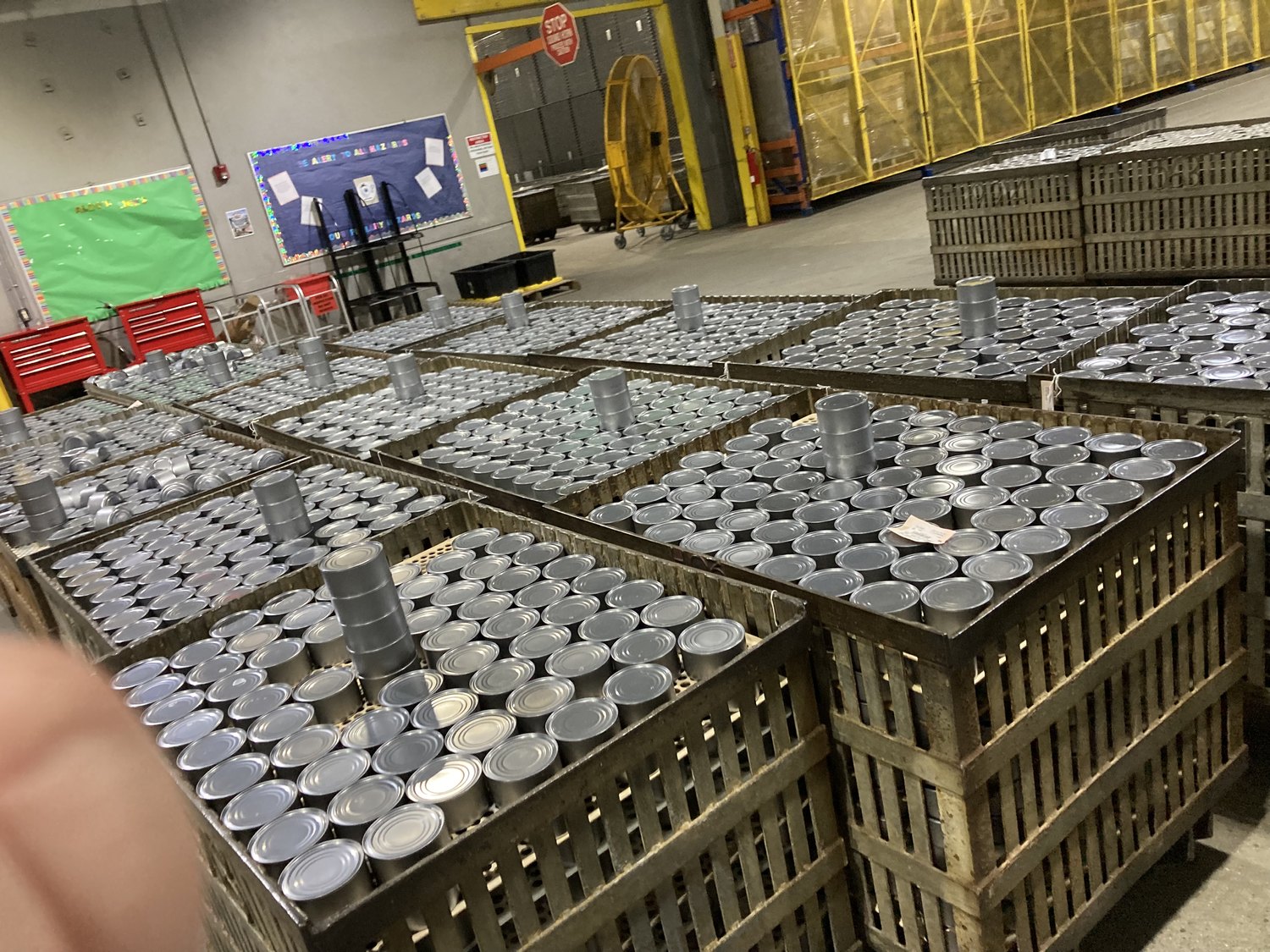Cans staged for code and label verification at a cannery